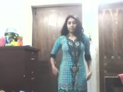 An beautiful Indian woman with long hair flaunts her vibrant sari.